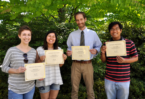 students holding Martin scholarship certificates with faculty