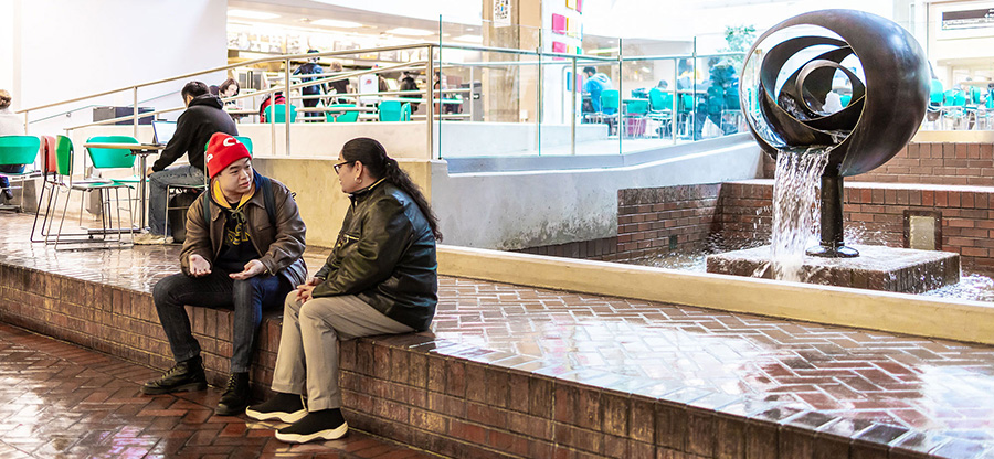 Seattle Central College students sit in front of Tsutakawa Fountain
