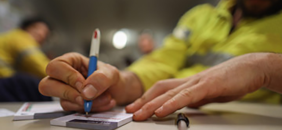  person writing on a notepad 