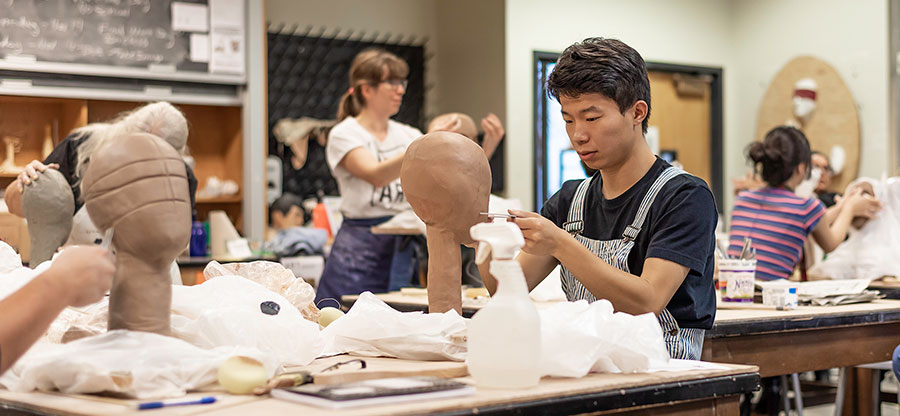  North Seattle College student working in ceramics class 