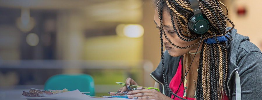 Seattle Central College student studying in the Atrium lunch area