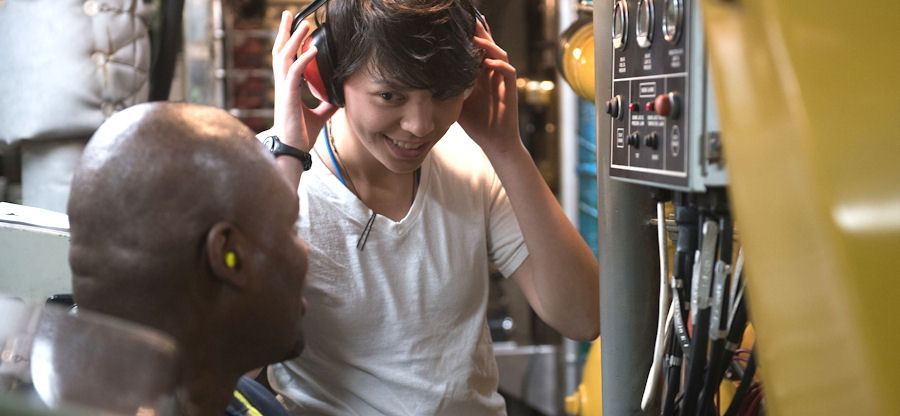 student working with equipment and headphones