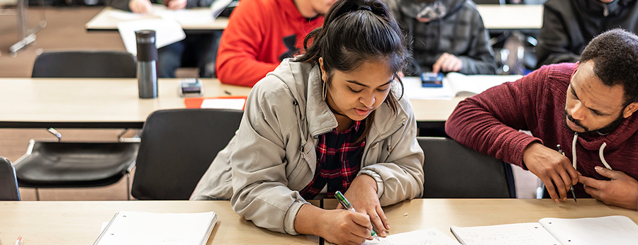  students at a table in a classroom 