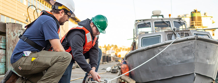 Seattle Central College Maritime students tying knots on a pier