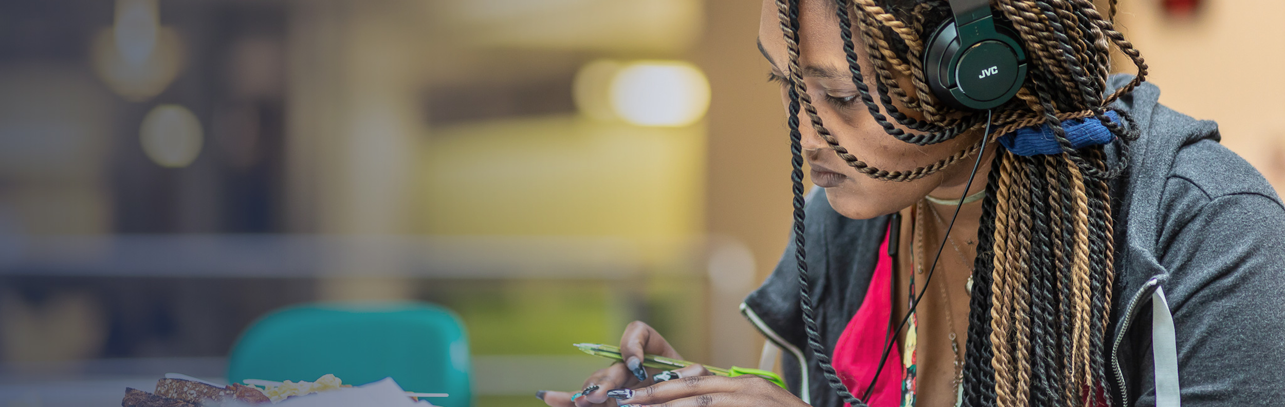 student writing at a table 