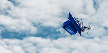  A graduation cap and tassel tossed into the air 