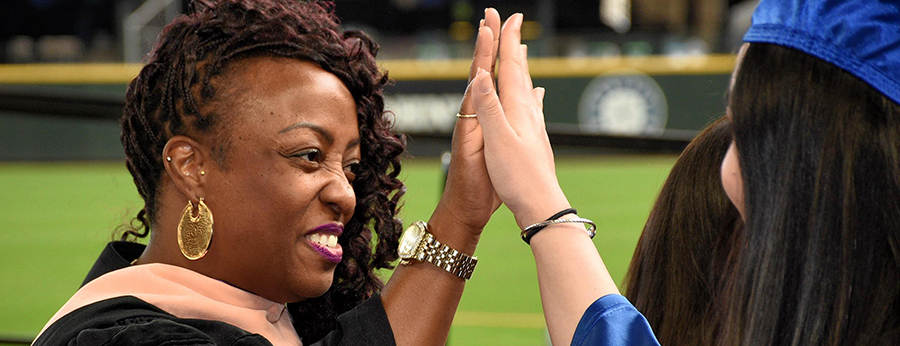  faculty member and student high-fiving 