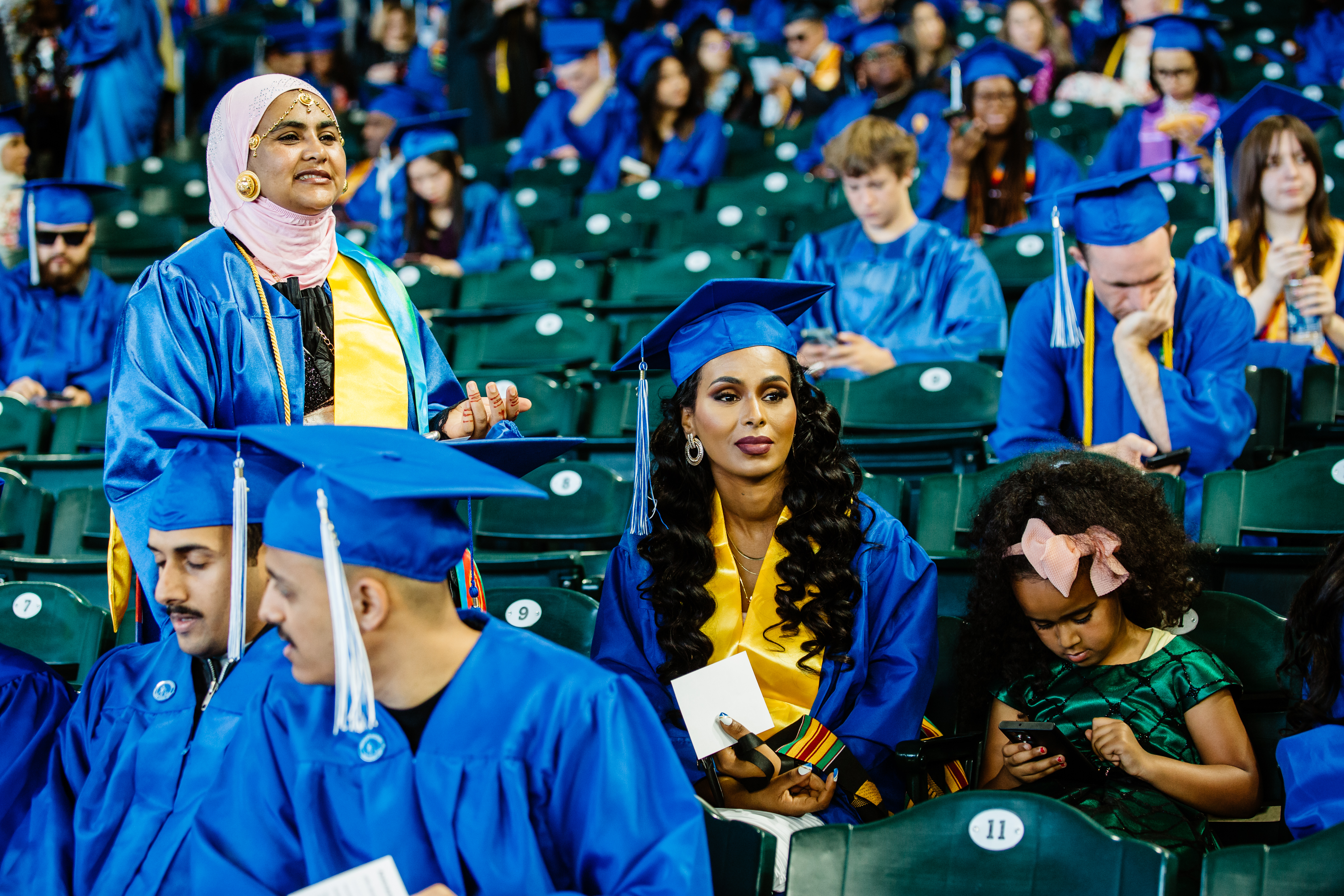 Student waiting in the stadium for the ceremony to begin