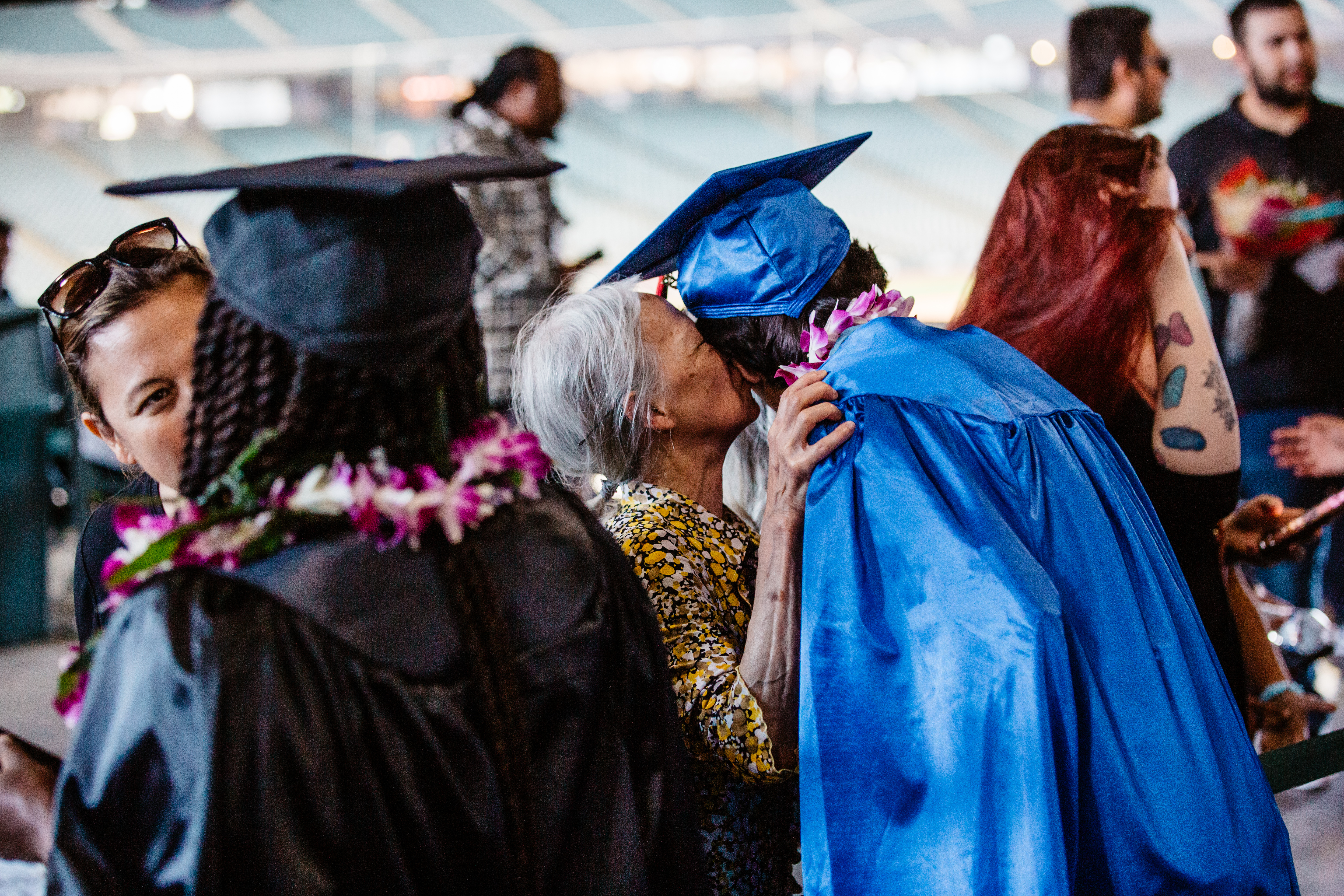 in the concourse a parent congratulates a graduate