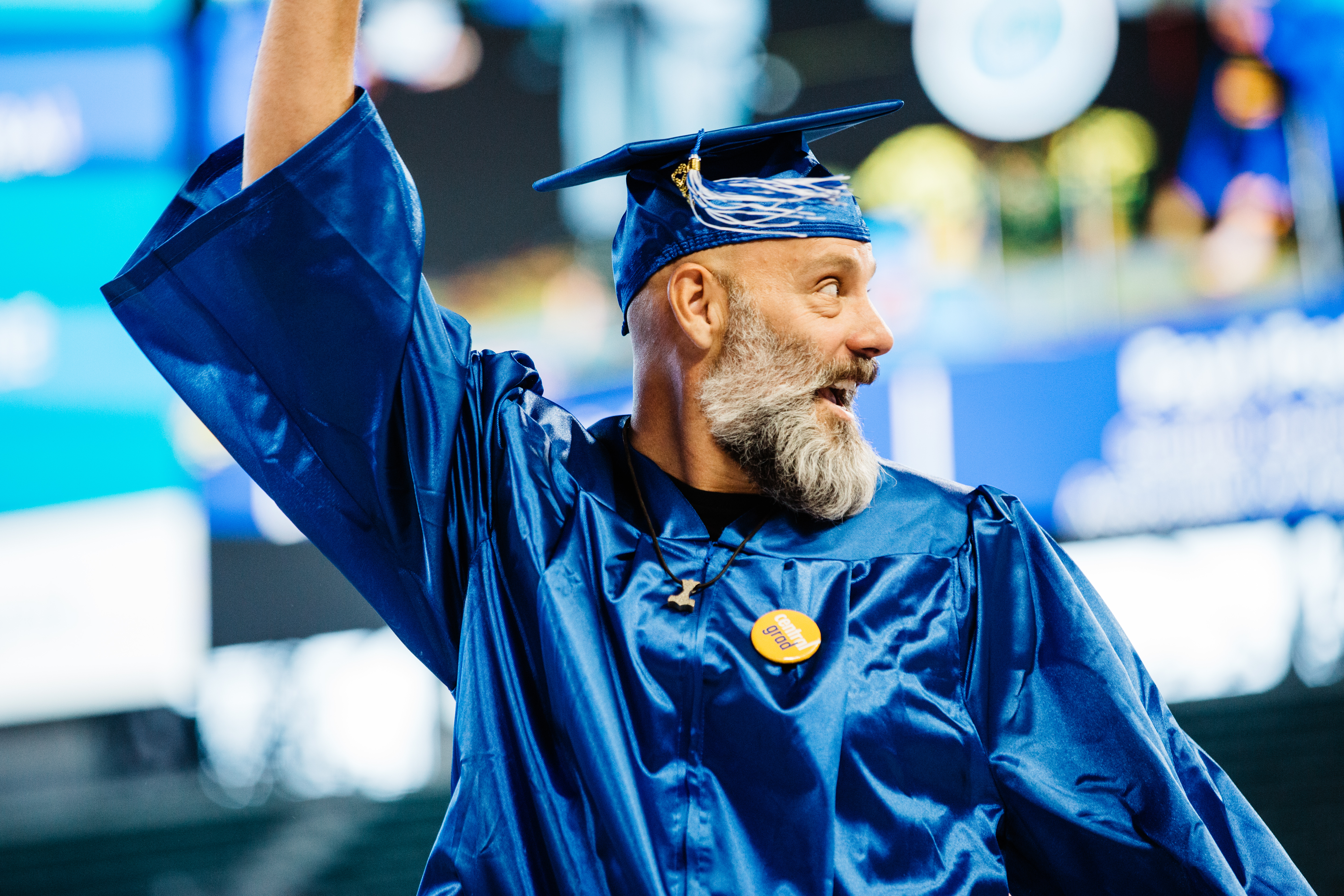 student celebrating his walk across the commencement stage