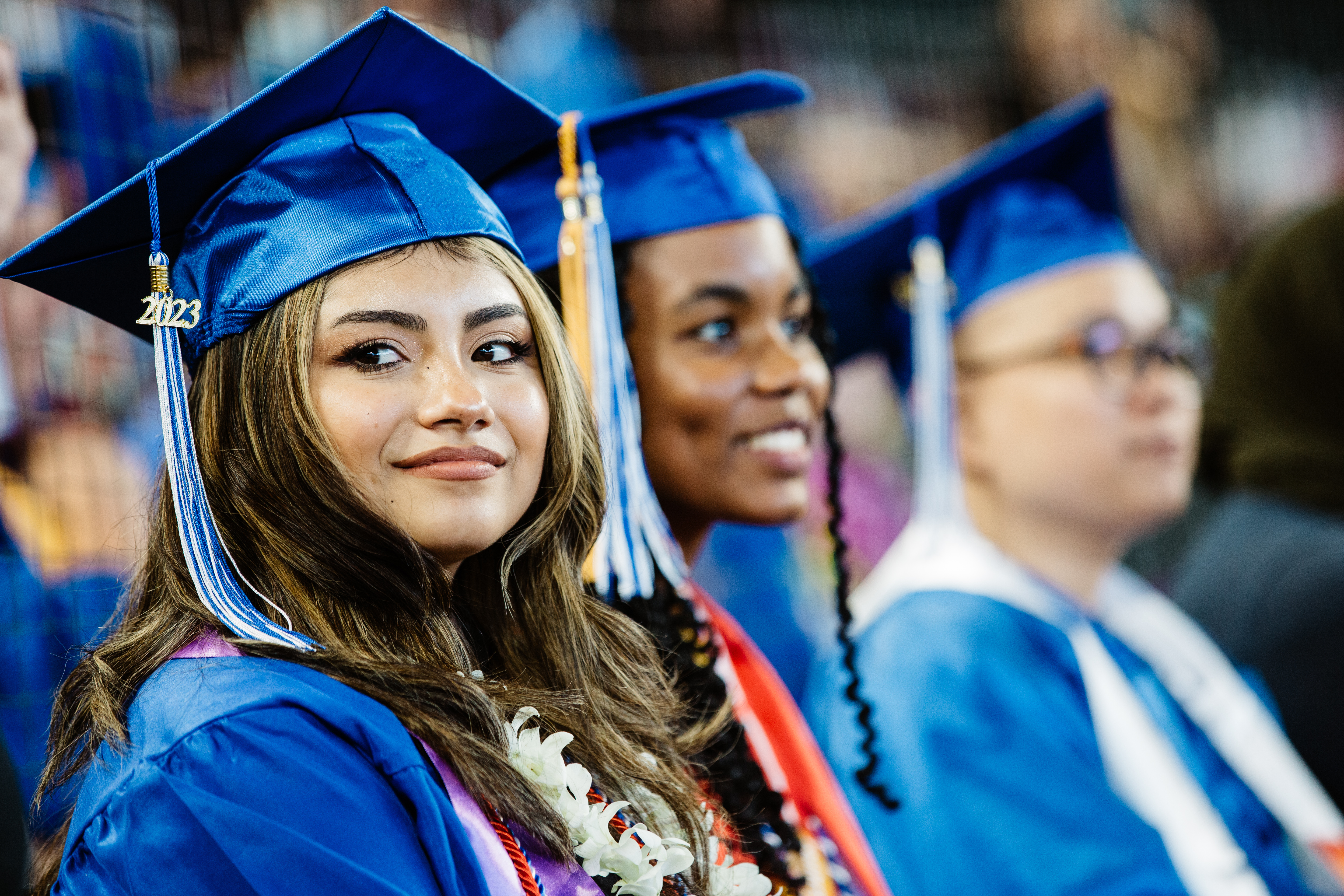 smiling students seated at ceremony