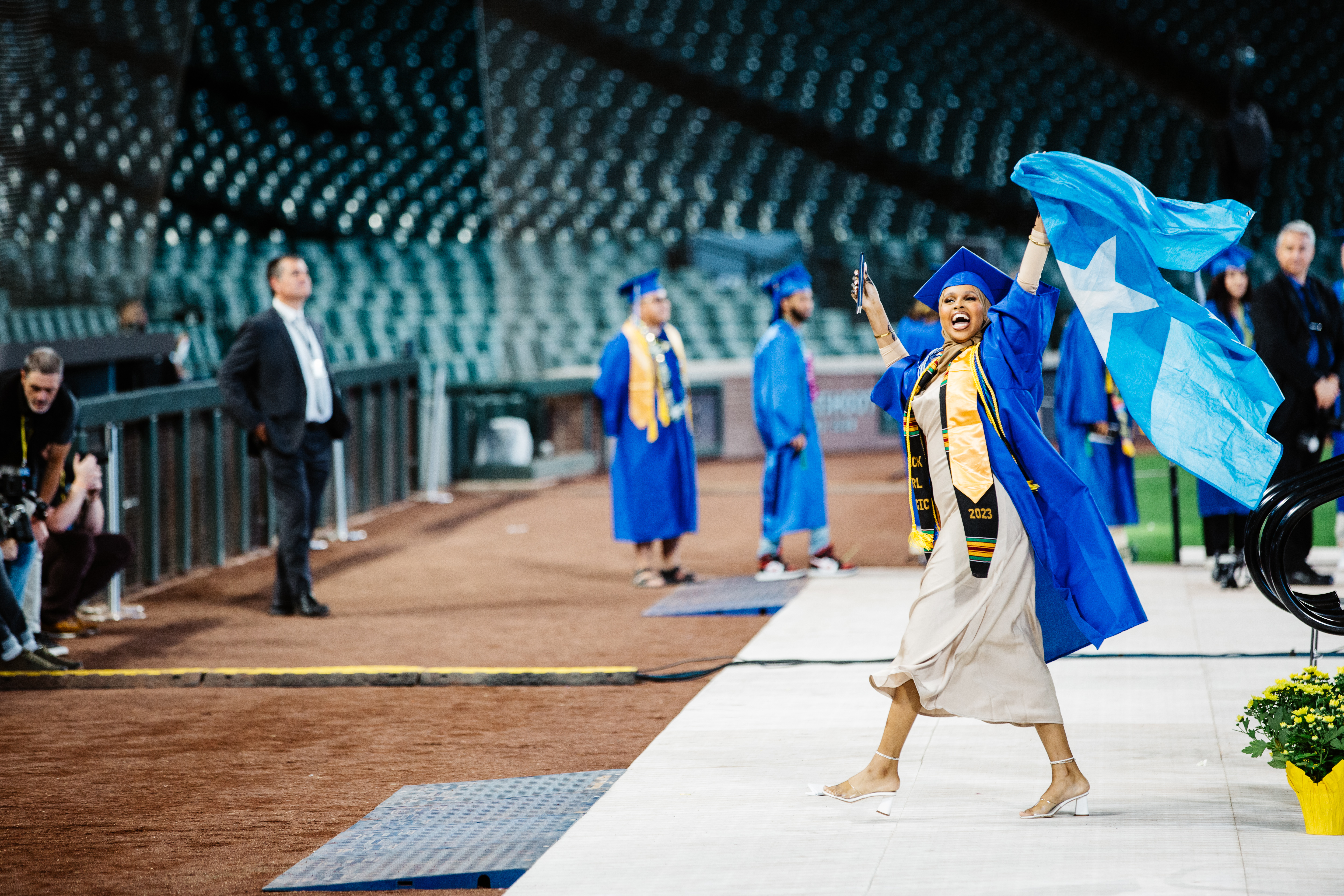 student celebrating her walk across the commencement stage