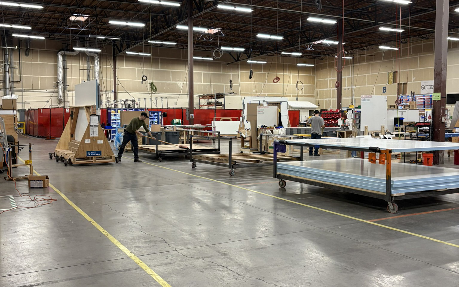 Pallet Shelter facilities at their location in Everett, WA. The photo depicts their production floor, with different areas used for different intents.