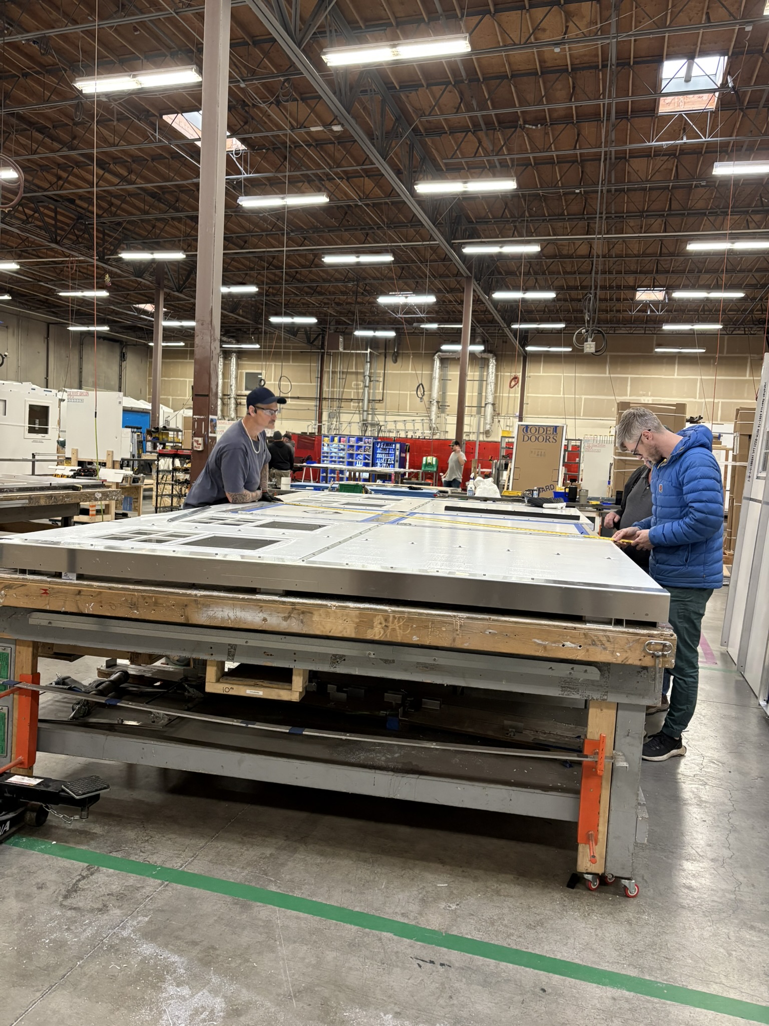 Photo showing the Pallet Shelter teams hard at work ensuring quality standards are met.