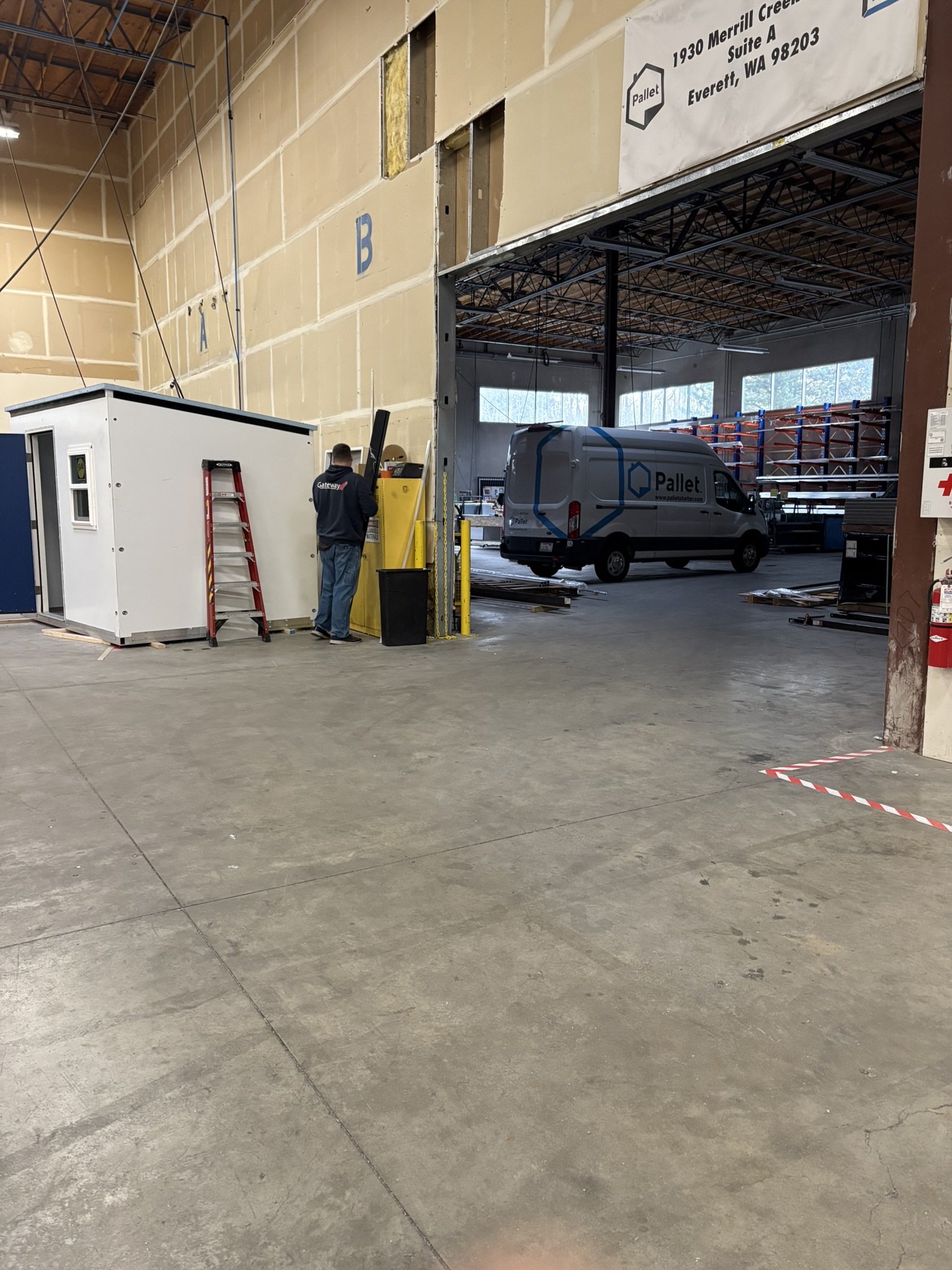 Photo showing the loading bay and a distribution vehicle, along with some storage areas in Everett, WA.