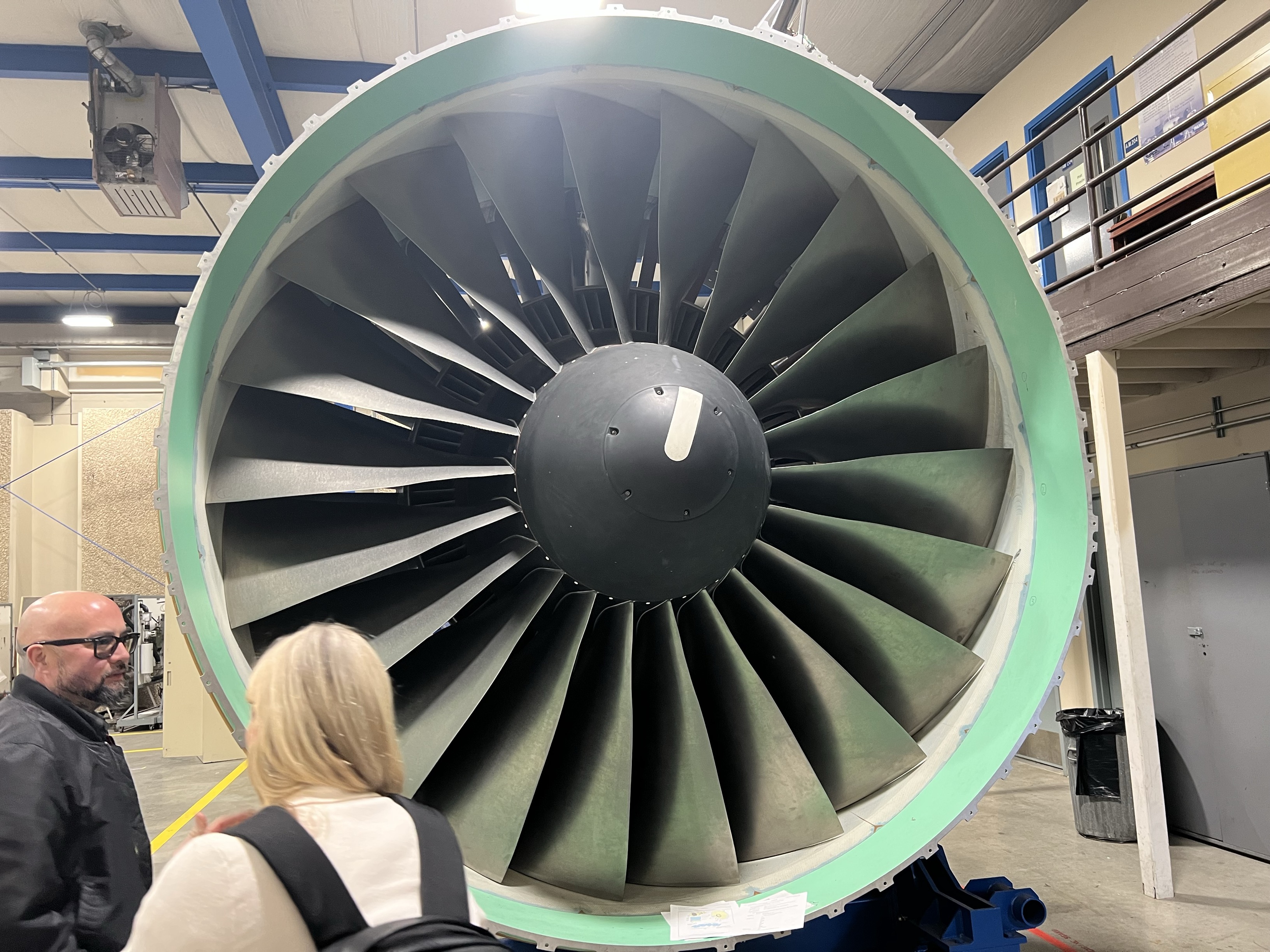 Ferdinand Orbino and Boeing's Megan admiring the scale of a plane turbine during the visit.