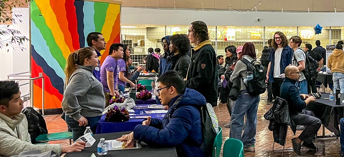 a group of students interacting in Central's Atrium for a networking event