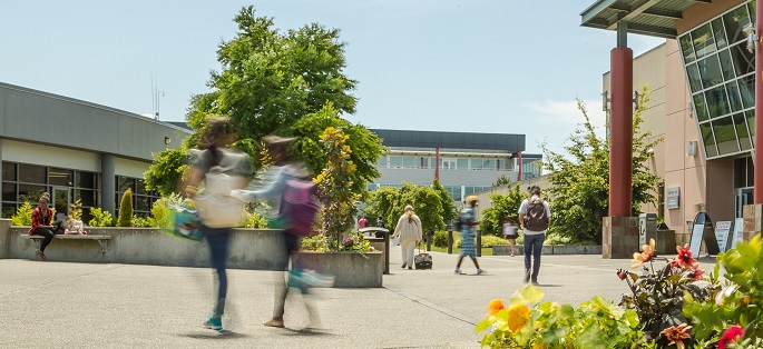 Students walking outside on campus at South