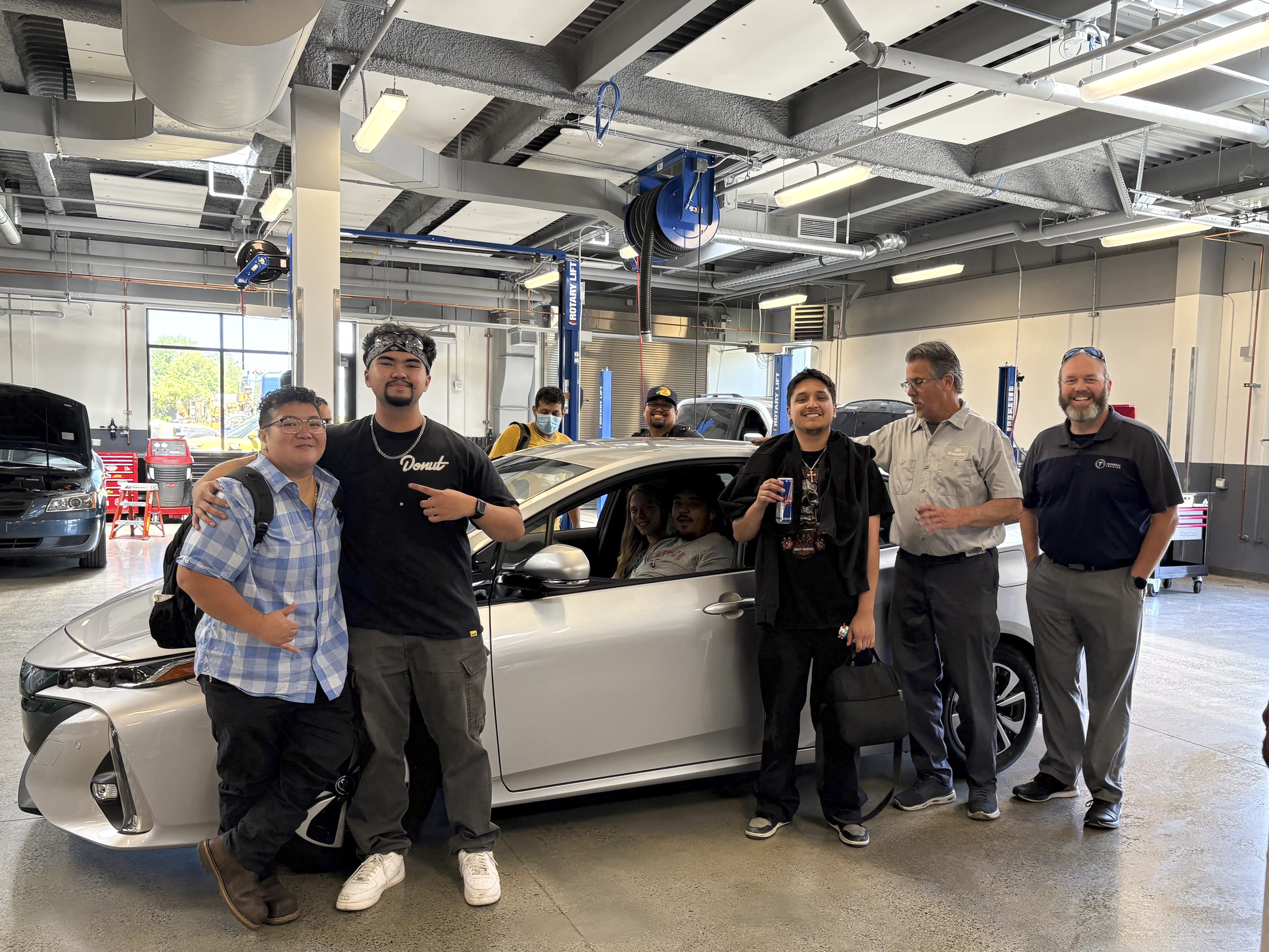 South Seattle College students and leadership with the newly acquired Toyota Prius Prime at South's campus.