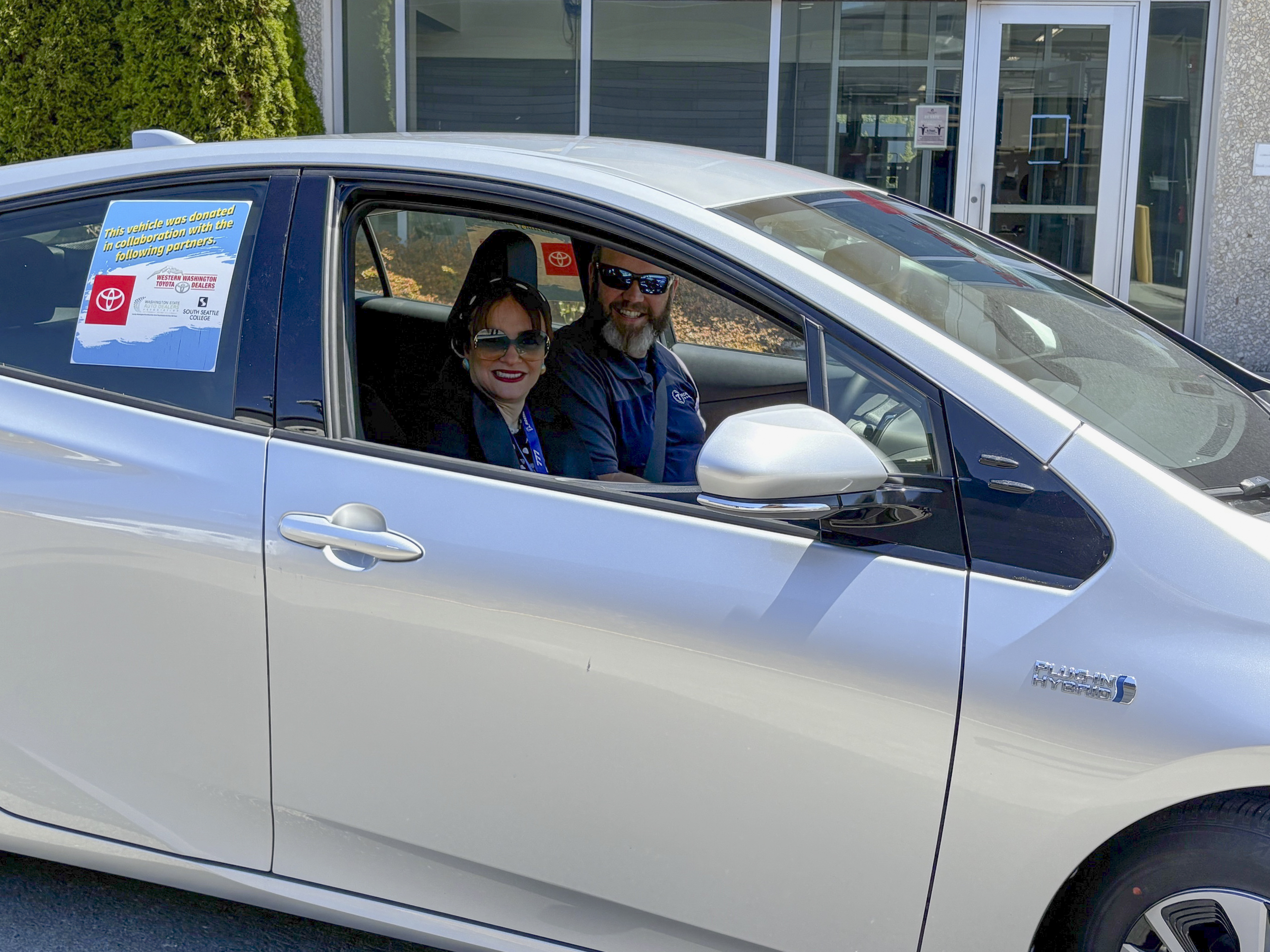 Dr. Dalia Sherif, Senior Executive Director of Seattle Colleges District Workforce Development, with Brian Hebert (Technical Services, Training and Dispute Resolution Manager at Toyota North America) aboard the newly received Toyota Prius Prime.