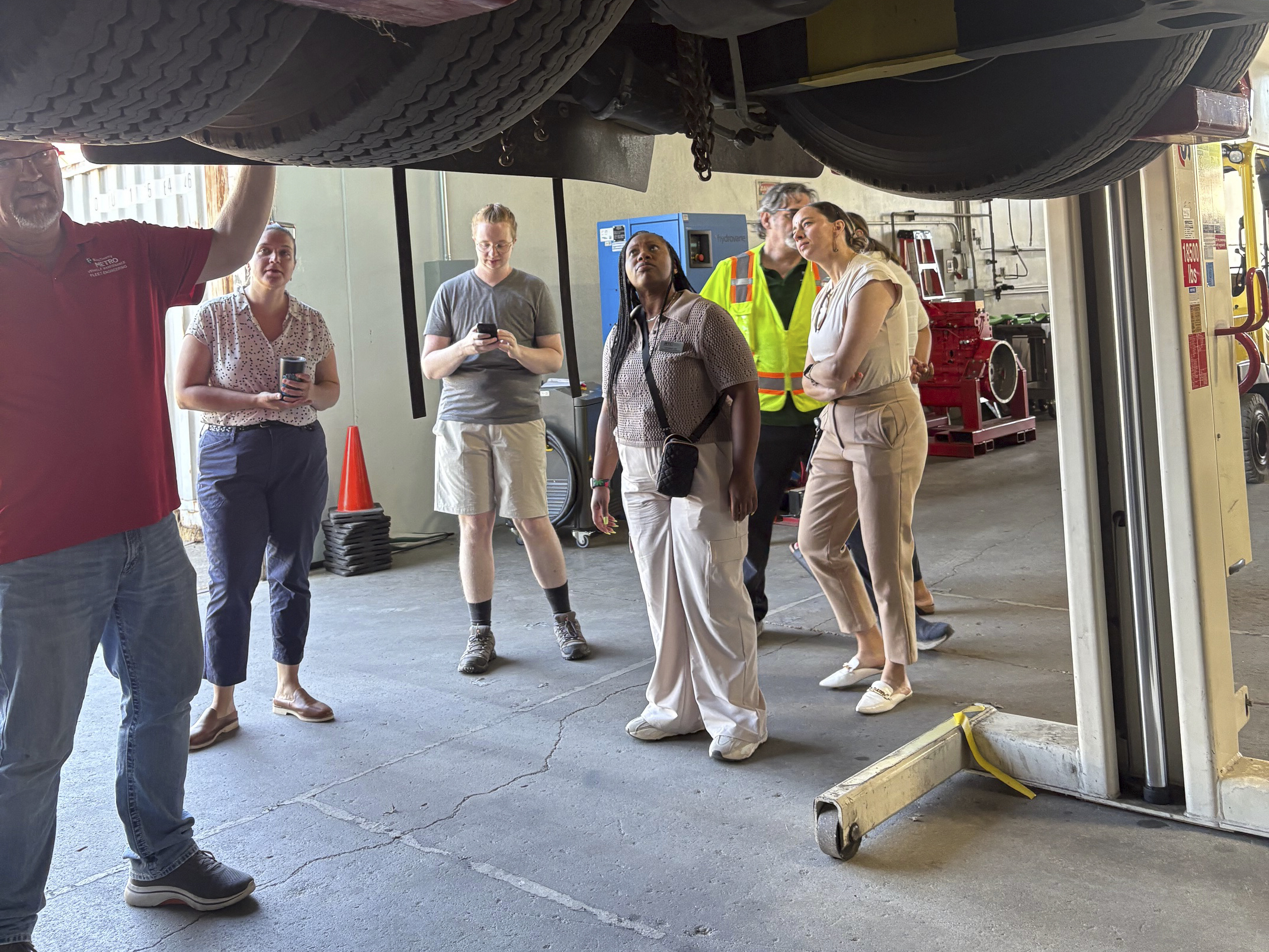 Part of the tour of King County Metro's facilities, featuring a view of the underside of a bus.