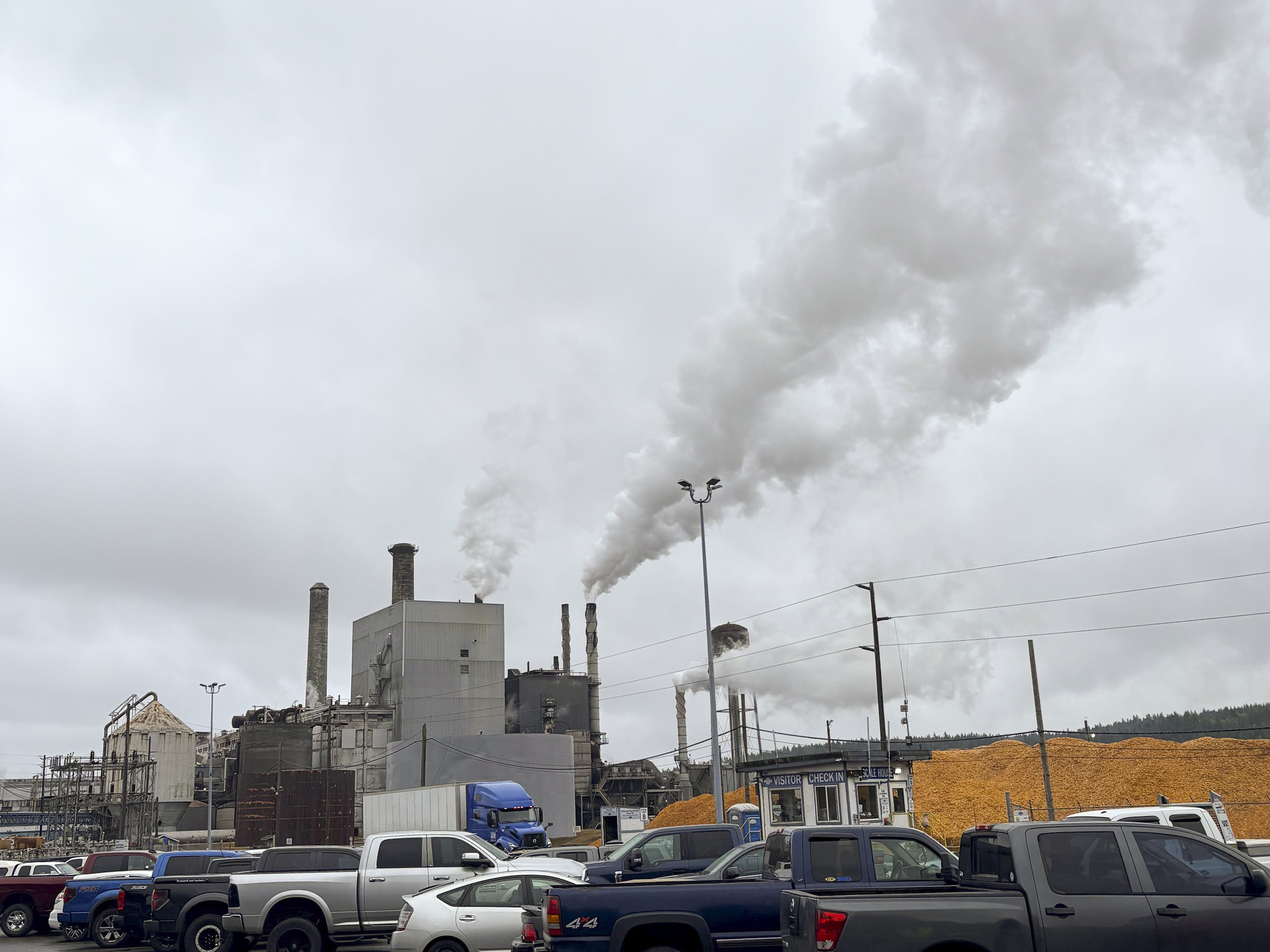 A view of the skyline above Port Townsend, where the corporation's facilities can be seen with a plume of steam above them.