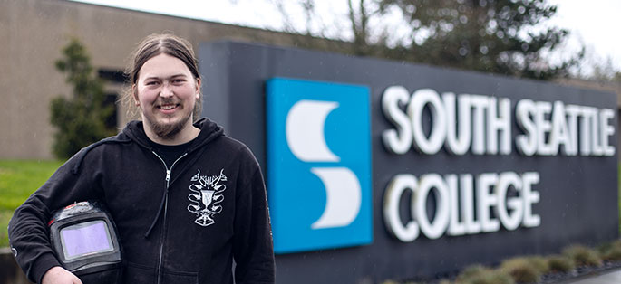Floyd smiling in front of South Seattle College exterior