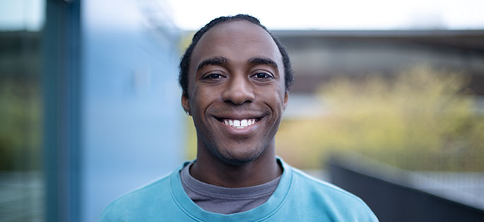 Vlad smiling in North Seattle College greenspace