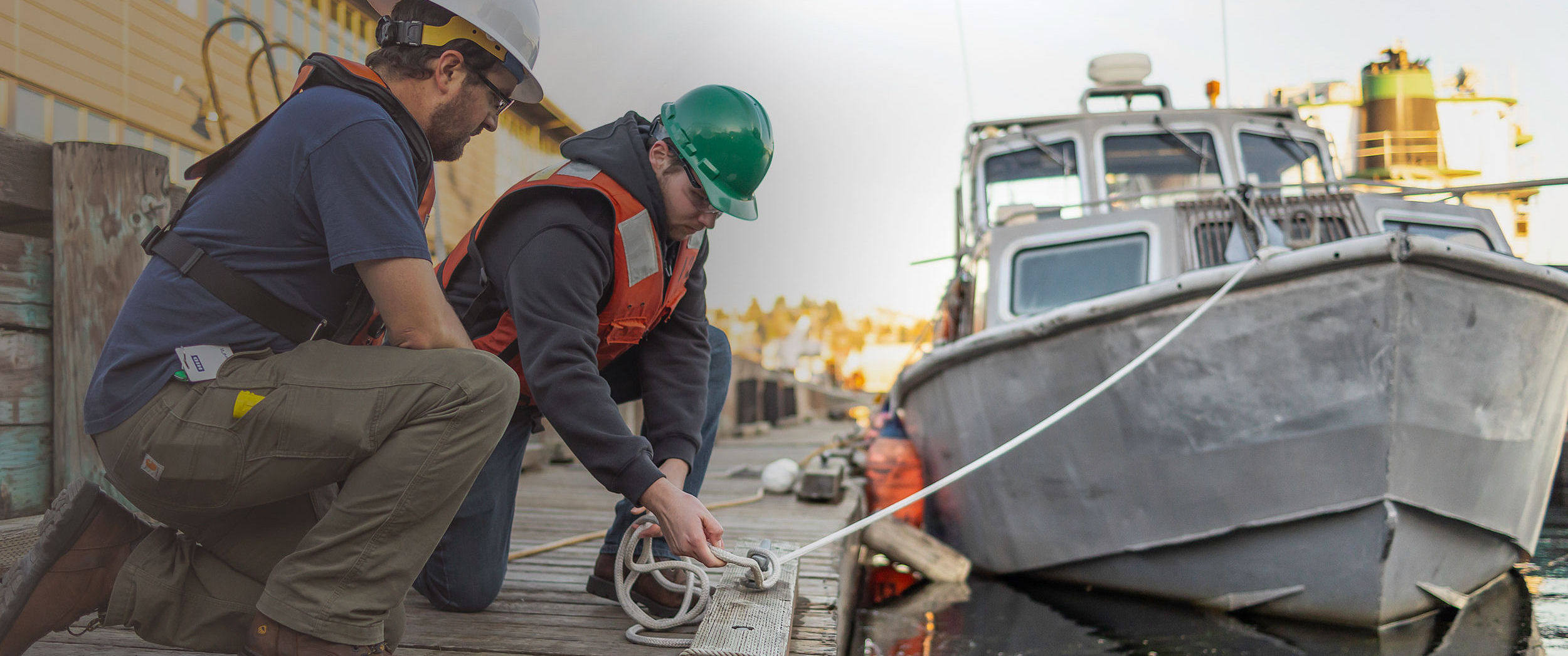 Seattle Central College Maritime students tying knots on a pier