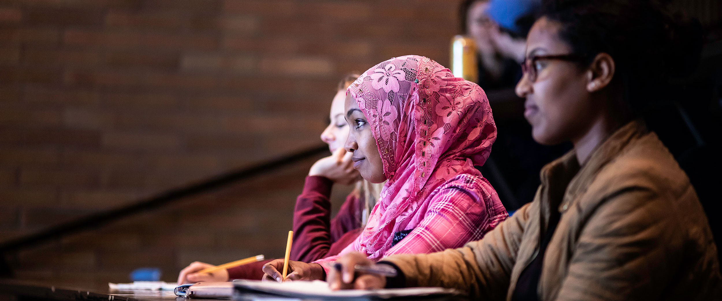 North Seattle College students taking notes in a lecture hall