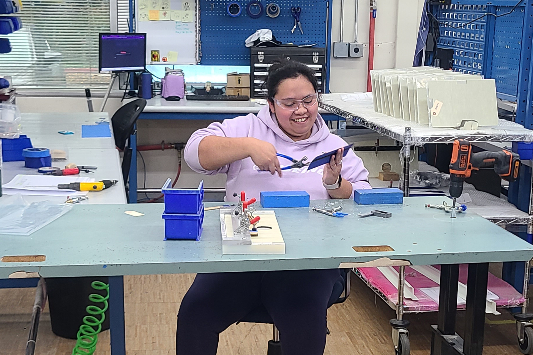 A student at the Pathfinder facilities, working on assembling parts