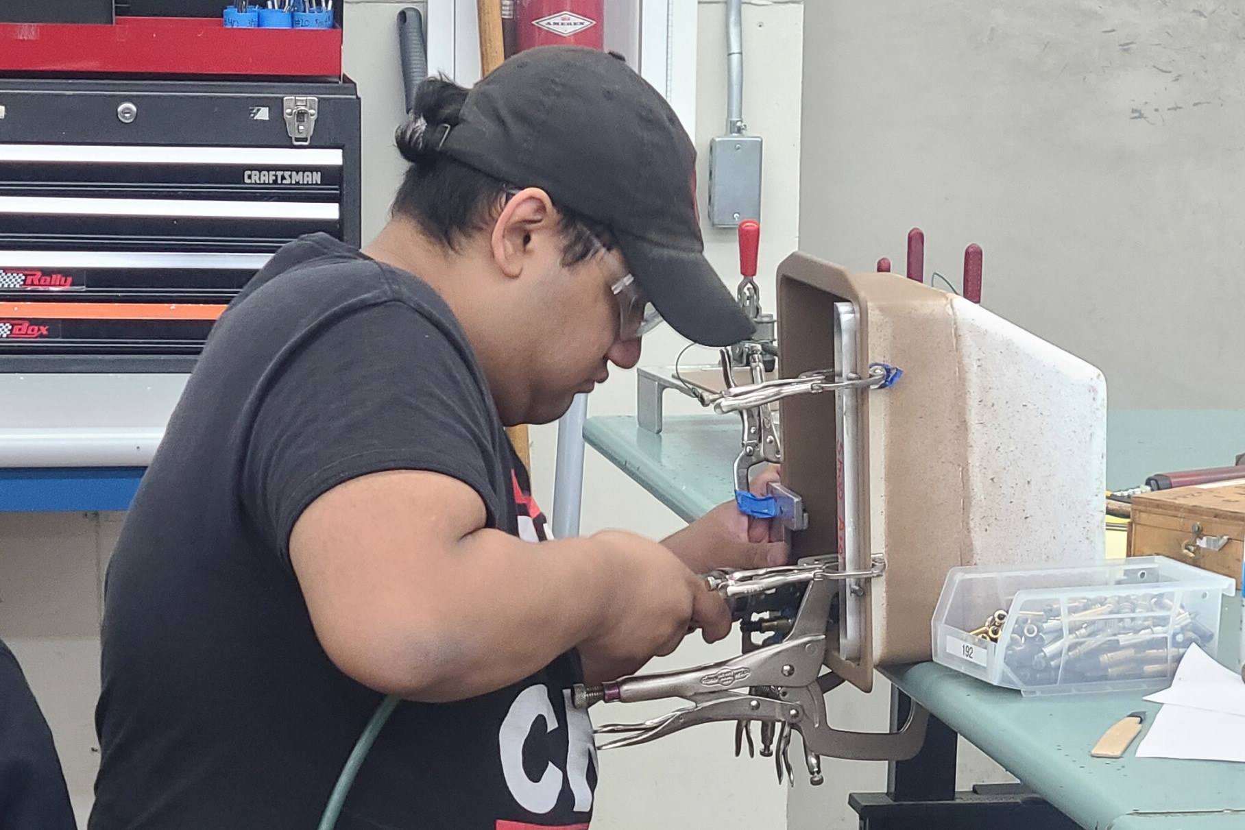 A student at the Pathfinder facilities, working on assembling parts