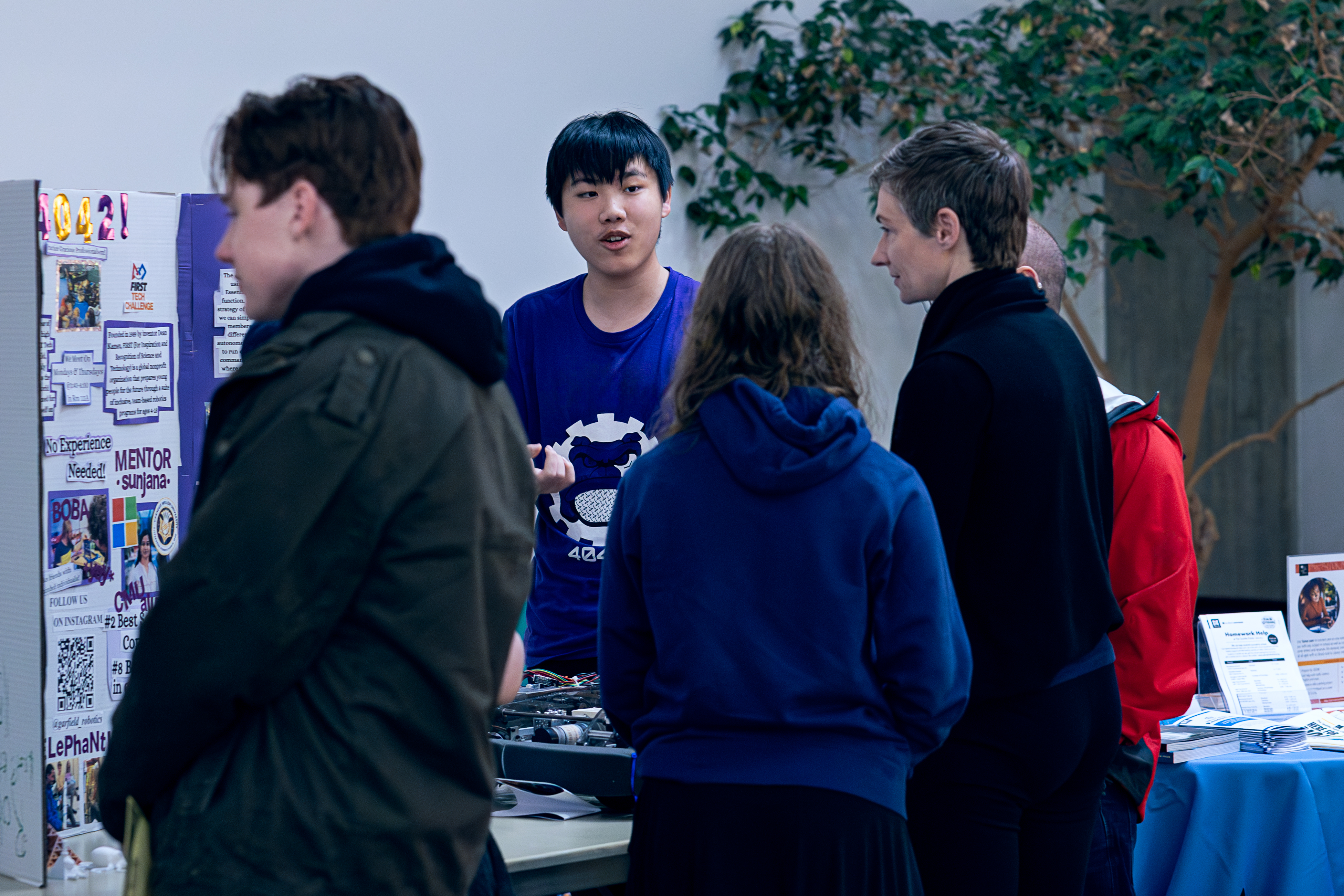 Attendees viewing booths with representatives speaking