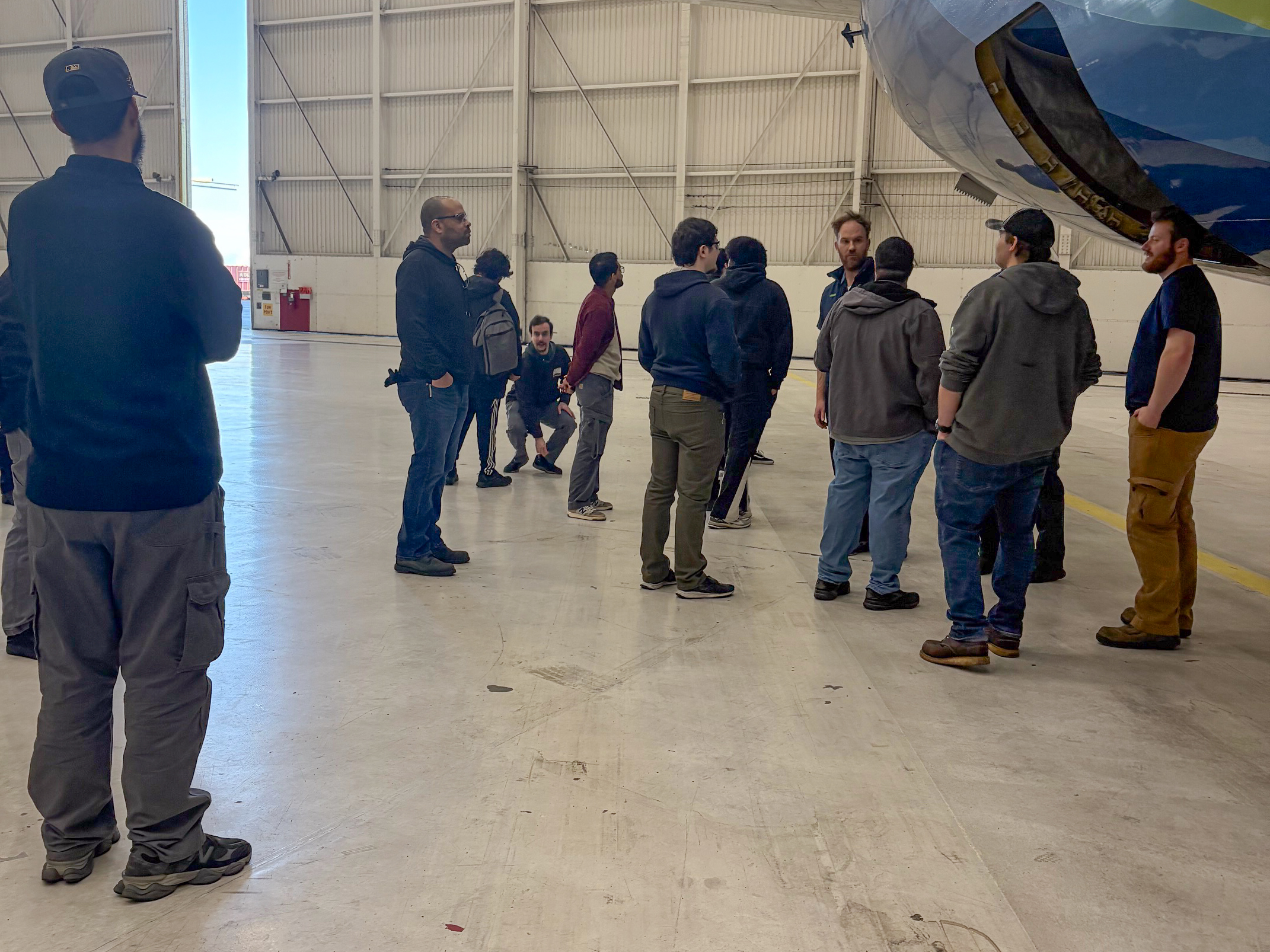 AMT Mentorship Program Students Touring Alaska Airlines Facilities Walking Around the Plane at the Hangar