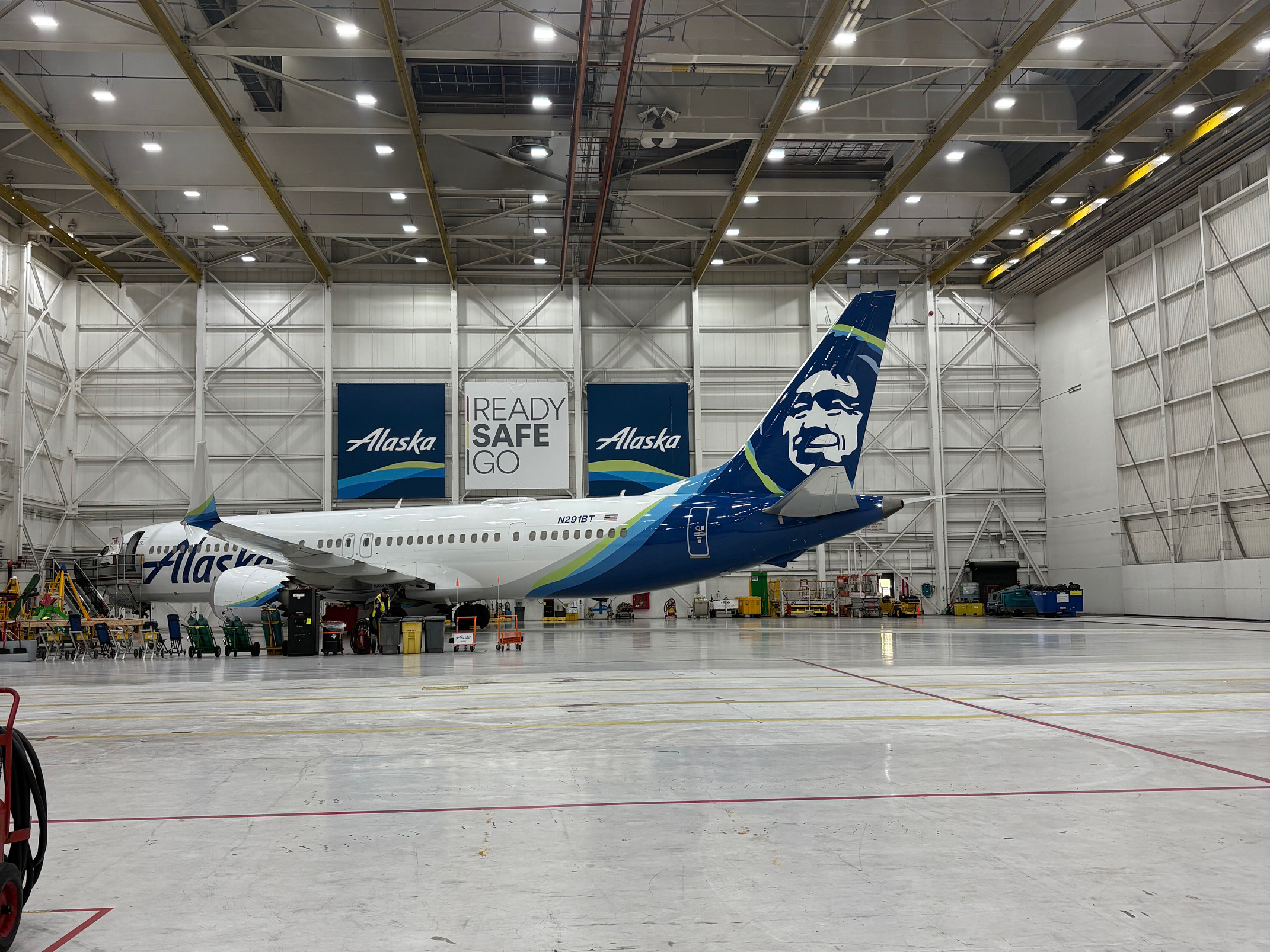 AMT Mentorship Program Students Touring Alaska Airlines Facilities Walking Around the Plane at the Hangar