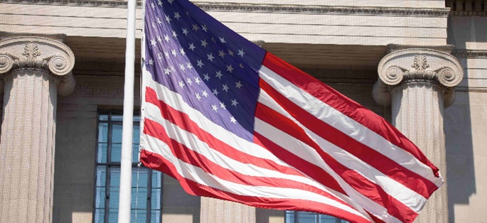 the U.S. flag flying outside a federal building