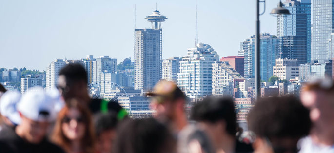 Seattle skyline with a diverse group of people in the foreground