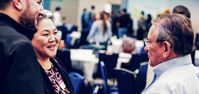 three employees engaged in a discussion