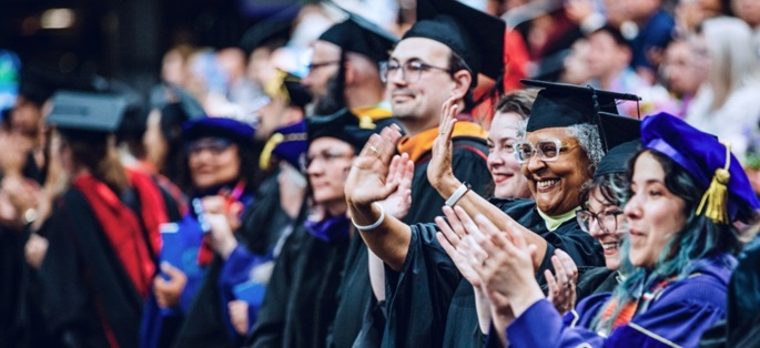 A diverse group of faculty members in academic regalia