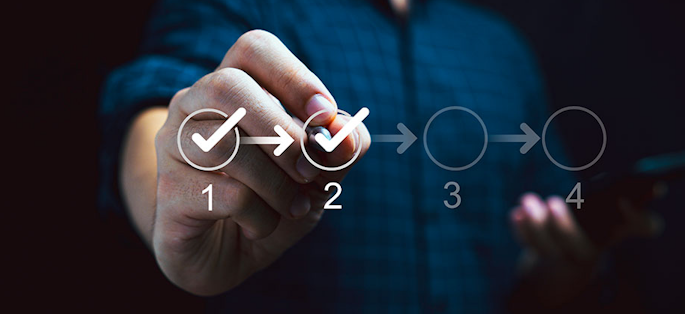 Person touching circles with a pen to tick correct mark in a checklist