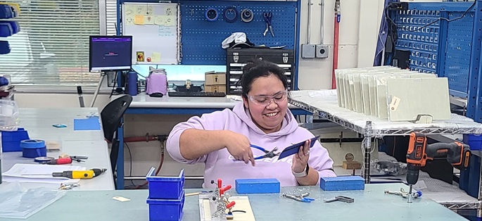 A woman in a manufacturing production setting.