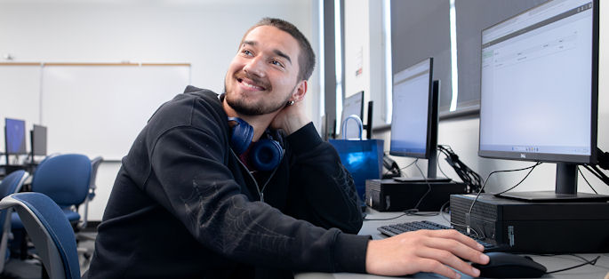 a male student at a computer