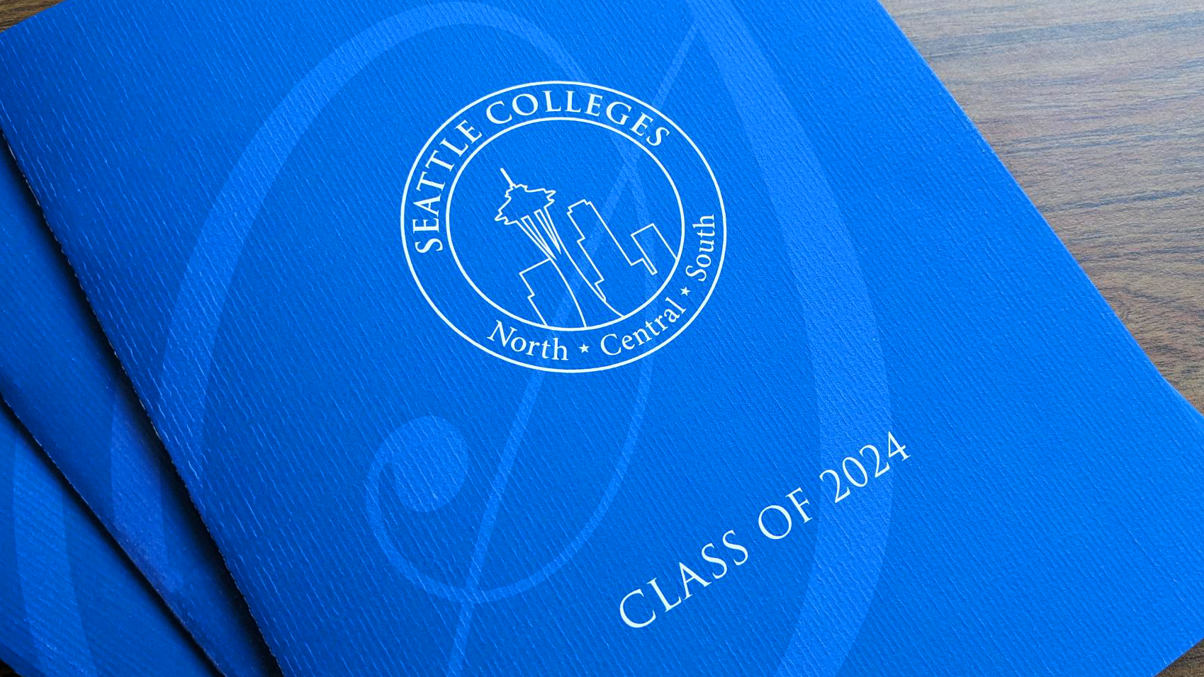 cover of the printed program: blue background with Seattle Colleges seal and North, Central, South with text: Class of 2024