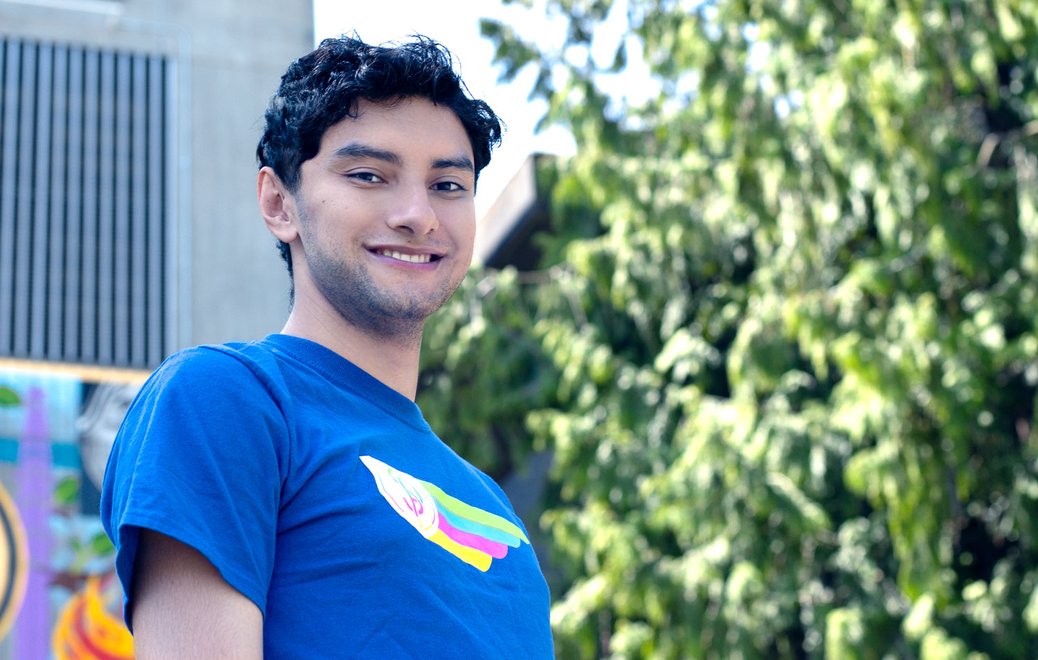 Kevin Martinez smiling in front of North Seattle College trees