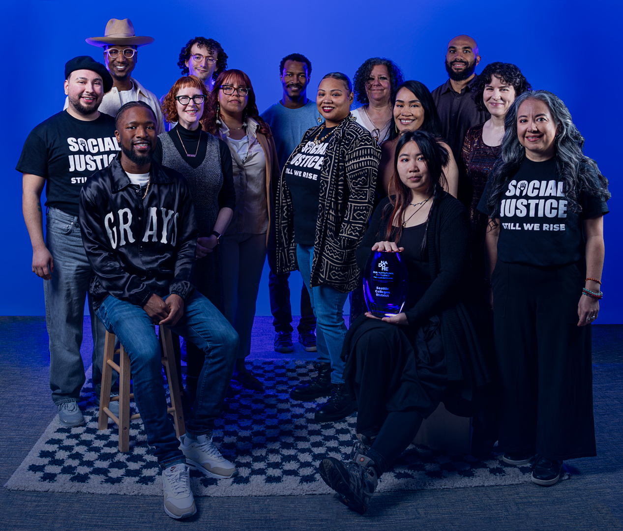 A group of 14 staff members who are part of the Division for Access, Community, and Opportunity at Seattle Colleges with the Institutional Excellence Award