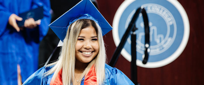 student in cap and gown at commencement