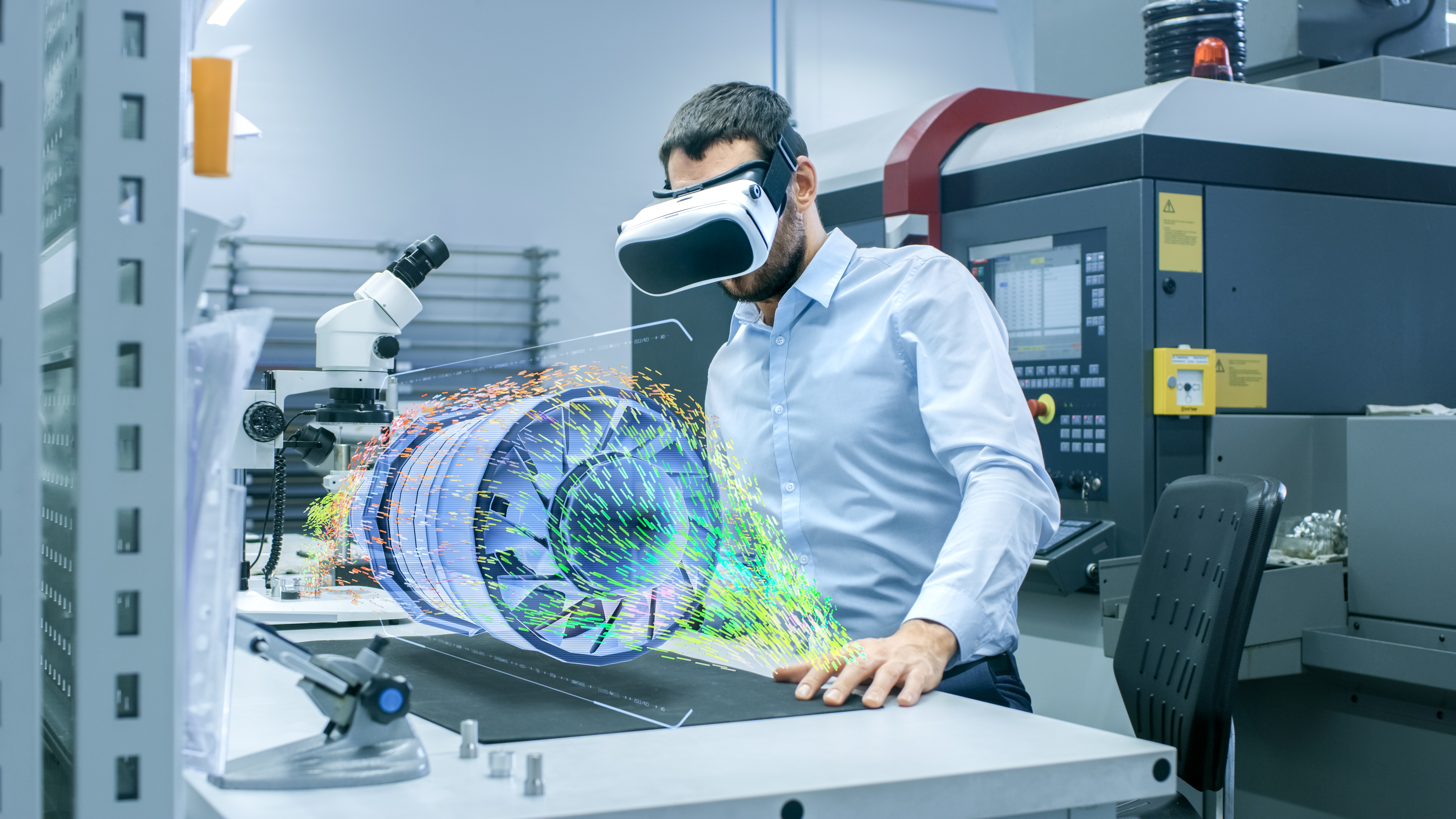 person wearing extended reality goggles and looking at a holographic image