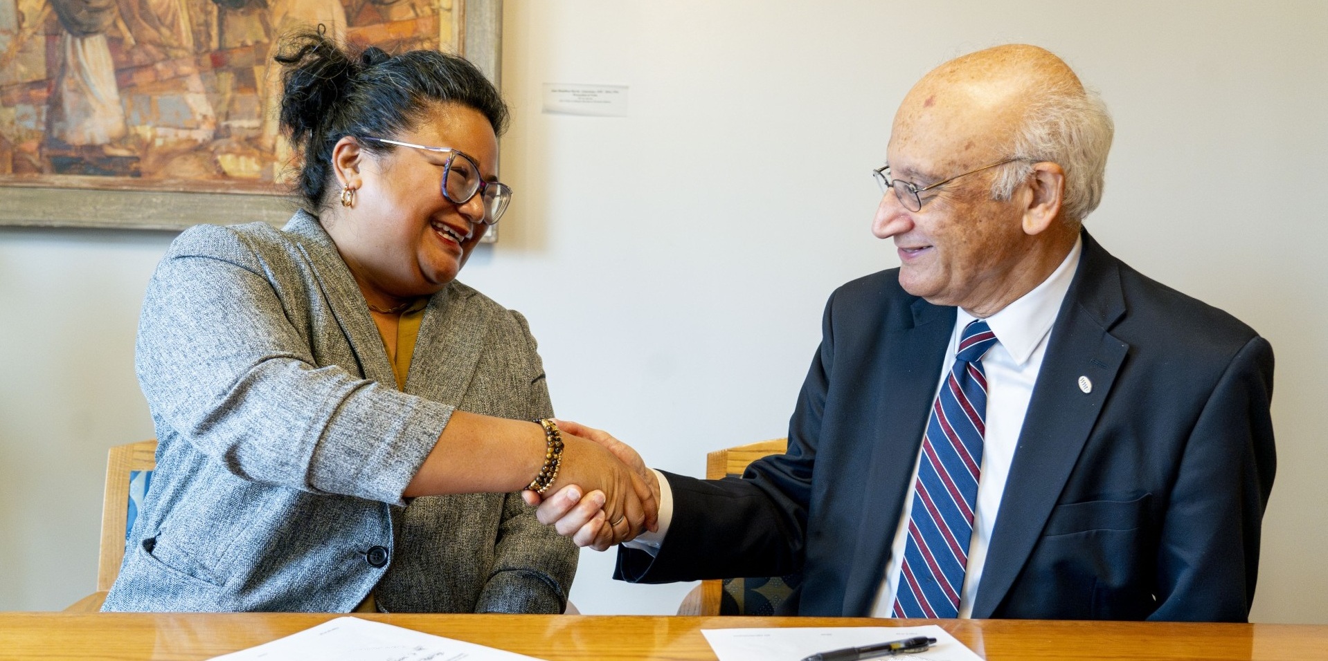 Seattle Colleges Chancellor Rosie Rimando-Chareunsap and Western Washington University President Sabah Randhawa shaking hands at agreement signing