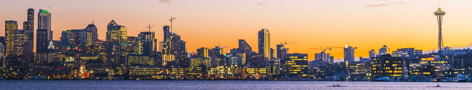 Seattle skyline at sunset featuring skyscrapers and the Space Needle from the vantage point of Lake Washington