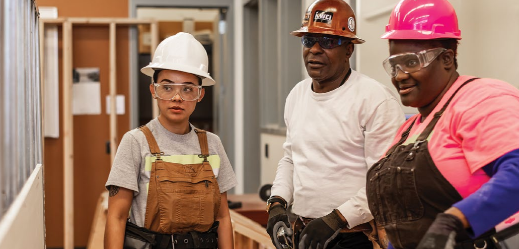 three construction students wearing hard hats